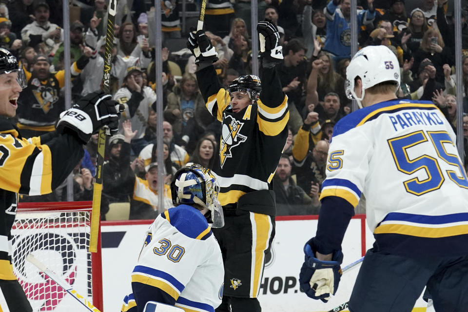 Pittsburgh Penguins' Evgeni Malkin, center top, celebrates after scoring against St. Louis Blues goaltender Joel Hofer (30) during the second period of an NHL hockey game Saturday, Dec. 30, 2023, in Pittsburgh. (AP Photo/Matt Freed)
