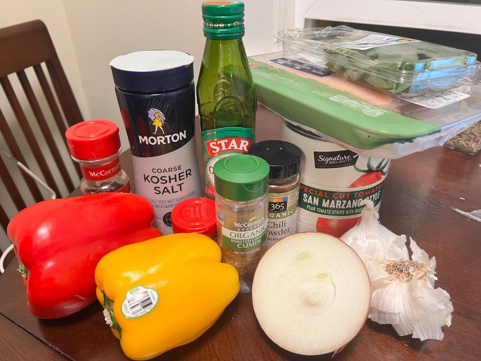 Bell peppers, onion, spices on table