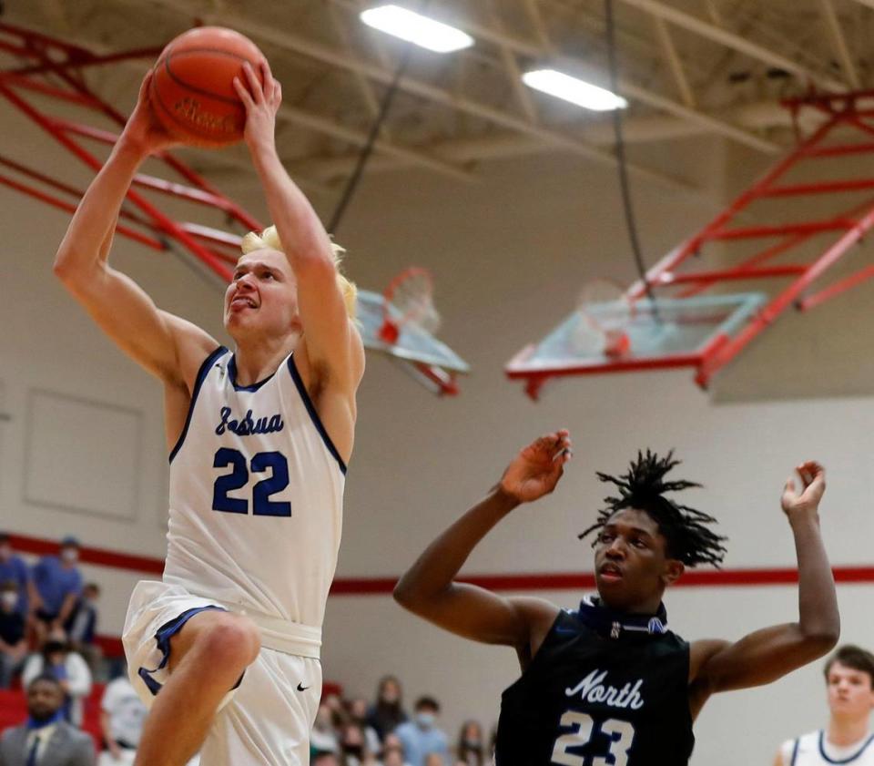 Joshua guard Tyler Stone (22) puts one in ahead of North Forney guard Jaden Jefferson (23) during the first half of a 5A region 2 bi-district basketball game at Grapevine High School in Grapevine, Texas, Tuesday, Feb. 23, 2021. North Forney led Joshua 17-12 at the half. (Special to the Star-Telegram Bob Booth)