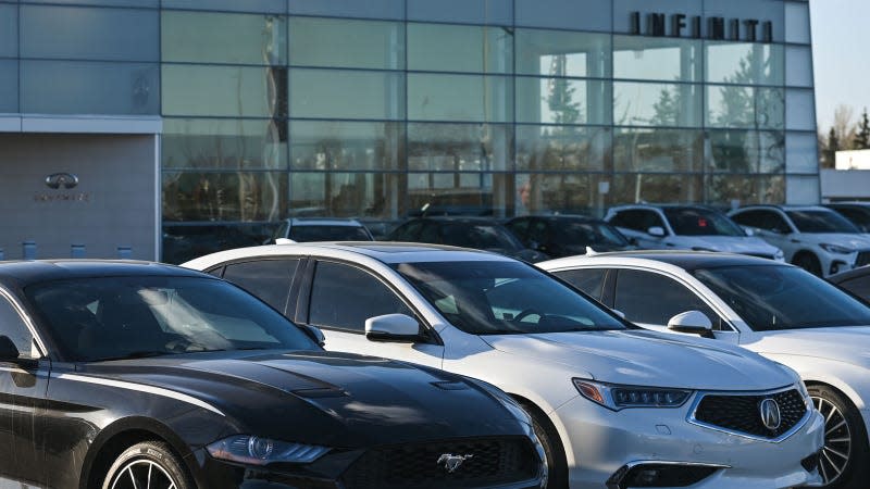 A photo of cars on the forecourt at a dealership. 