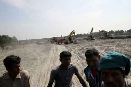 FILE PHOTO: Excavators are seen on the island of Bhasan Char in the Bay of Bengal, Bangladesh February 14, 2018. REUTERS/Stringer/File Photo