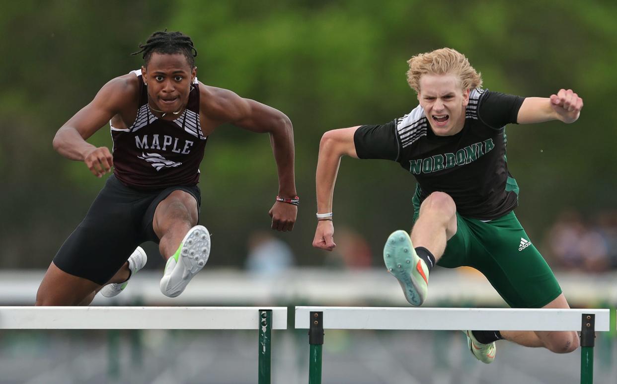 Nordonia's Matthew Hayes, right, competes in the boys 300-meter hurdles during the Division I district track meet at Nordonia High School on Friday.