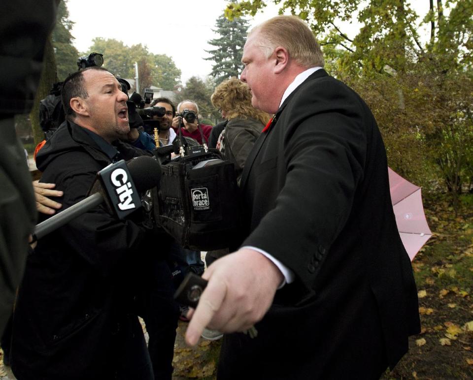 File-This Oct. 31, 2013, file photo shows Toronto Mayor Rob Ford telling the media to get off his property as he leaves his home in Toronto. Pop star Justin Bieber is giving Ford a brief respite as Canada's favorite bad boy and butt of all jokes. But the comparison may not be a fair one. The 19-year-old teen idol is facing the equivalent of a misdemeanor assault charge. Ford has admitted smoking crack while in a drunken stupor and is being sued for supposedly orchestrating the jailhouse beating of his sister's ex-boyfriend. (AP Photo/, Nathan Denette, File)