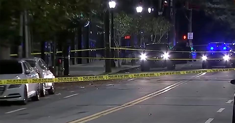 This image provided by WSB-TV shows police on the scene of a shooting that left multiple people injured in downtown Atlanta early Sunday morning, Oct. 29, 2023. In a statement Sunday, university officials confirmed that two students were among those wounded.