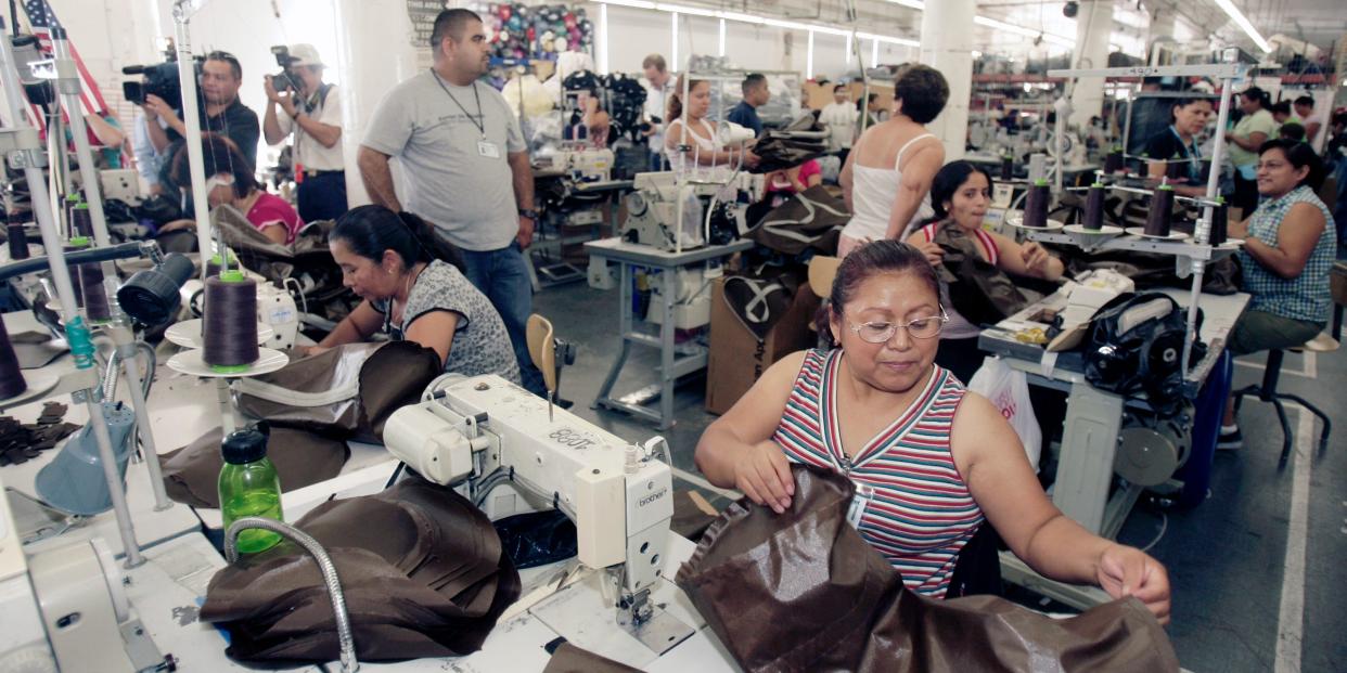 inside of garment factory with women sitting in front of sewing machines