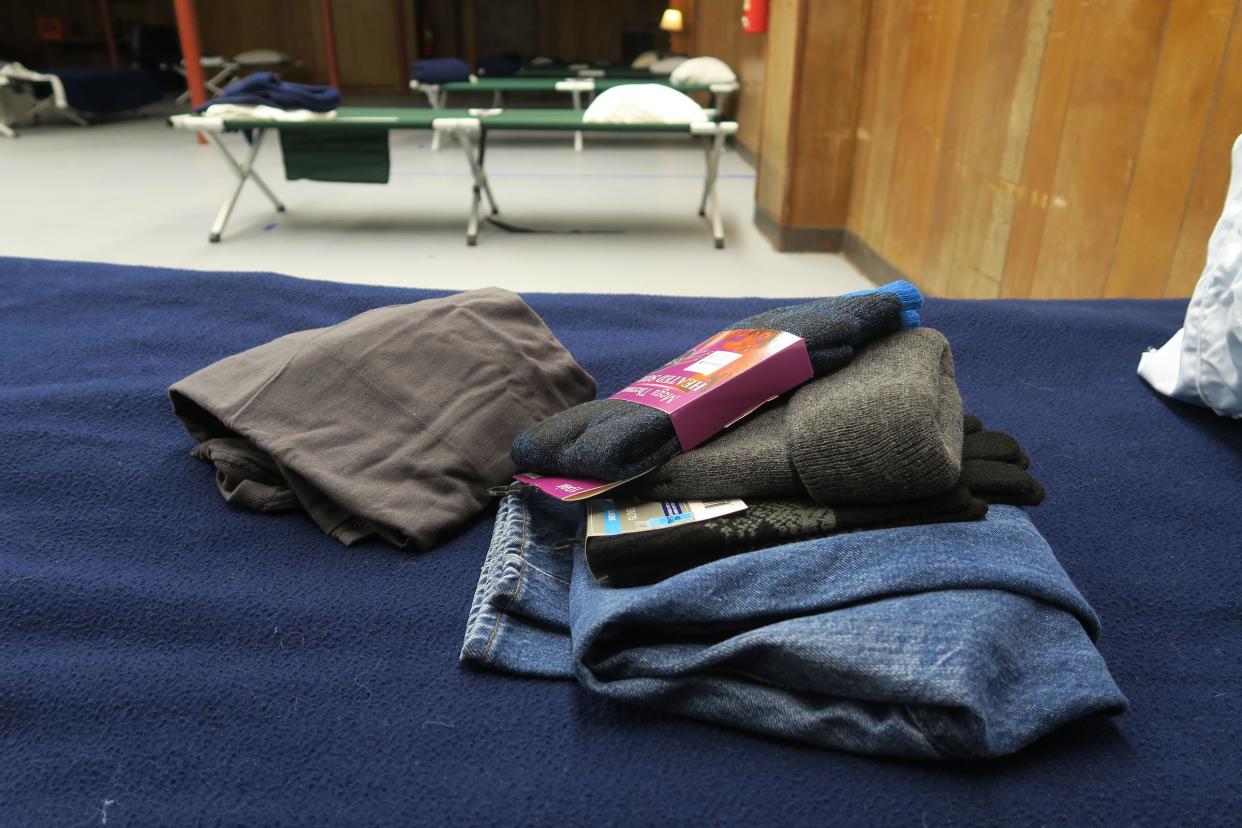 Fresh clothing sits on a cot Nov. 23, 2020, in the warming center at the Riverwood Park recreation building in Toms River.