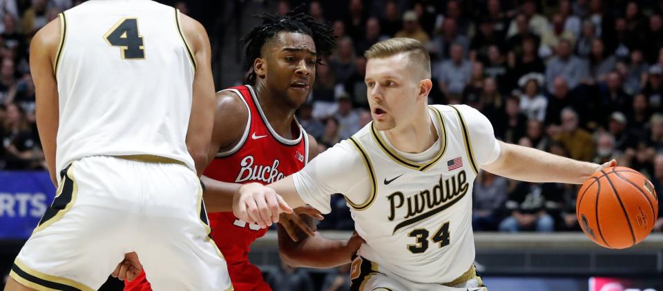 Purdue Boilermakers forward Trey Kaufman-Renn (4) sets a pick  on Ohio State Buckeyes forward Brice Sensabaugh (10) for Purdue Boilermakers guard Carson Barrett (34) during the NCAA’s men’s basketball game, Sunday, Feb. 19, 2023, at Mackey Arena in West Lafayette, Ind. Purdue won 82-55.