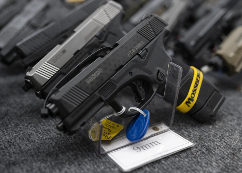 FILE - Pistols sit on display during the first day of the Silver Spur Gun and Blade Show Saturday, Jan. 22, 2022 in Odessa, Texas. On Friday, June 17, 2022, The Associated Press reported on stories circulating online incorrectly claiming a bill passed by the Democrat-led U.S. House of Representatives would criminalize disassembling, cleaning and re-assembling your gun without a firearm manufacturer’s license. (Eli Hartman/Odessa American via AP)