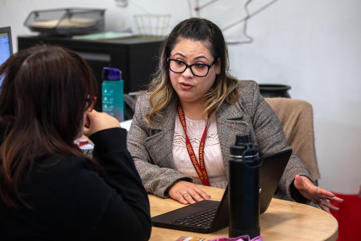 College counselor Jacqueline Villatoro, right, works with a student