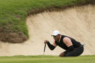 Tiger Woods lines up a putt on the 18th hole during the third round of the PGA Championship golf tournament at Southern Hills Country Club, Saturday, May 21, 2022, in Tulsa, Okla. (AP Photo/Matt York)