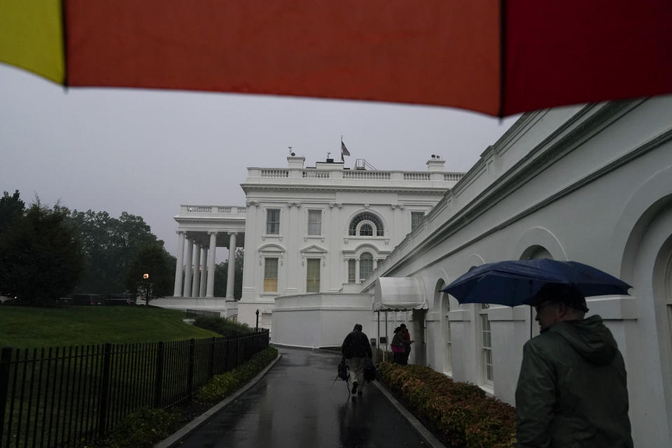 Members of the media walk to the press briefing room of the White House, Monday, Aug. 7, 2023, in Washington. Thousands of federal employees were sent home early Monday as the Washington area faced a looming forecast for destructively strong storms, including tornadoes, hail and lightning. (AP Photo/Jacquelyn Martin)