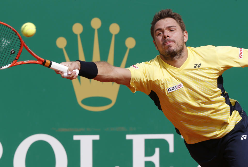 Stanislas Wawrinka of Switzerland, returns to the ball to Milos Raonic of Canada during their quarterfinals match of the Monte Carlo Tennis Masters tournament in Monaco, Friday, April 18, 2014. Wawrinka won 7-6 6-2. (AP Photo/Michel Euler)