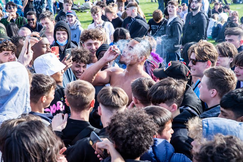 A man smokes cannabis amidst the thousand protesters gathering in London's Hyde Park