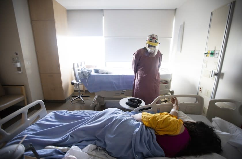 LOS ANGELES, CA - May 8: Quinnece Washington, 31, is an RN on the COVID-19 unit at Martin Luther King, Jr., Community Hospital on Thursday, May 8, 2020 in the Willowbrook neighborhood located in South Los Angeles, CA. She is working with a covid19 positive patient. (Francine Orr / Los Angeles Times)