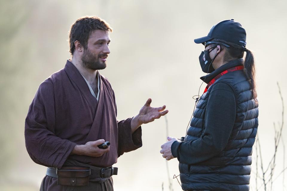 (R-L) "Shogun" producer Hiroyuki Sanada consults with Cosmo Jarvis as John Blackthorne on the set of the FX series.