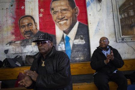 Audience members react as New York Mayor Bill de Blasio and police commissioner Bill Bratton speak at a news conference in the Brownsville neighborhood in the borough of Brooklyn, New York January 30, 2014. REUTERS/Eric Thayer