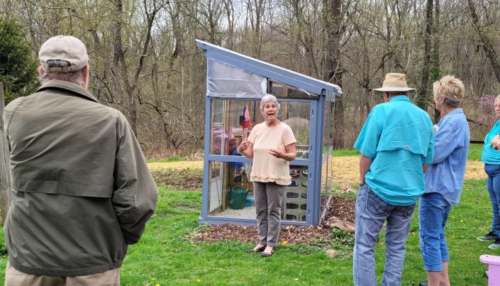 Linda Bush of rural Lakeville tells fellow Gardener&#39;s Guild members how she made this potting shed with scrapped building materials, including old windows, last summer at the April 25 meeting.