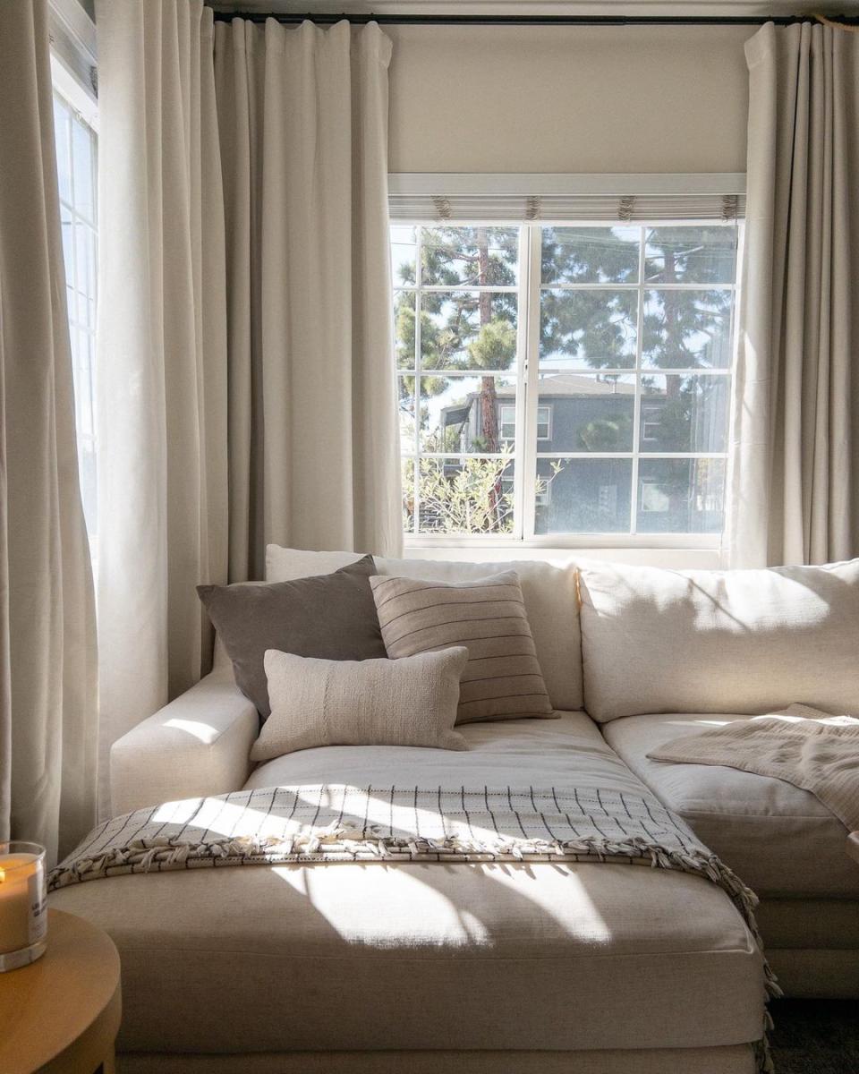 Neutral living room with beige couch and curtains