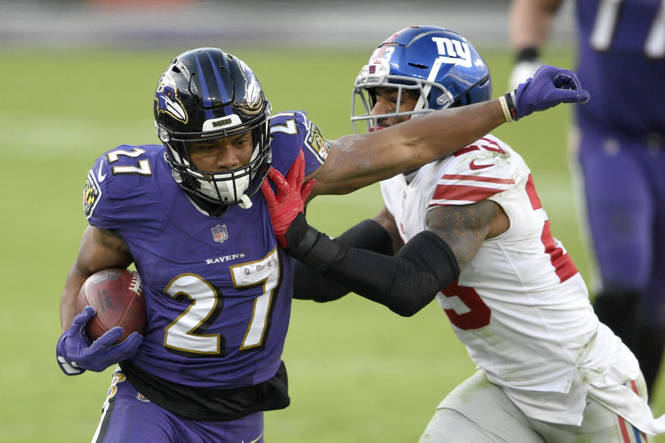 Baltimore Ravens running back J.K. Dobbins (27) is pushed out of bounds by New York Giants free safety Logan Ryan (23) during the second half of an NFL football game, Sunday, Dec. 27, 2020, in Baltimore. (AP Photo/Nick Wass)