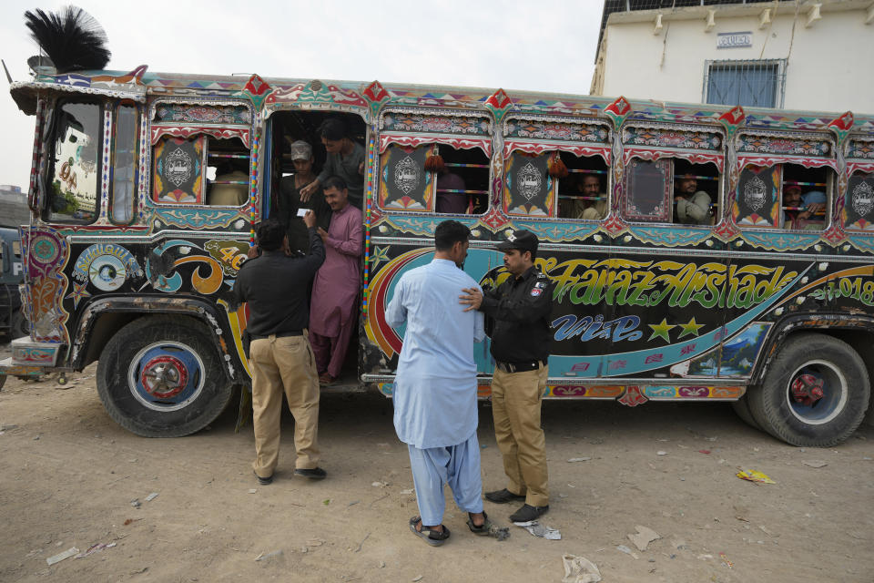 Police officers take into custody to immigrants for further data verification during a search operation against illegal immigrants in a neighbourhood of Karachi, Pakistan, Tuesday, Nov. 7, 2023. Pakistan government launched a crackdown on migrants living in the country illegally as a part of the new measure which mainly target all undocumented or unregistered foreigners. (AP Photo/Fareed Khan)