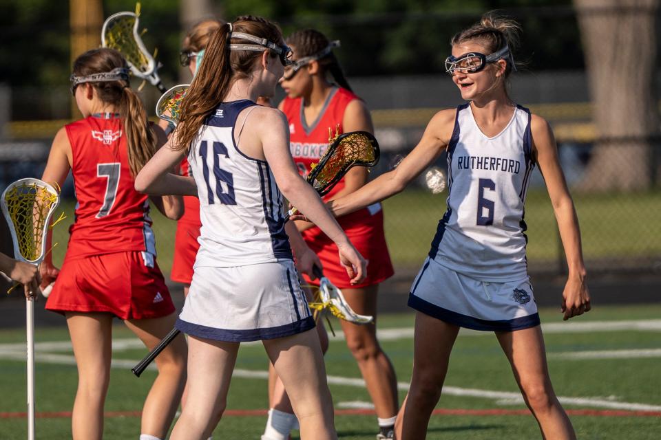 R #16 Fiona Waller and R #6 Maeve Murphy celebrate after the team scores. Rutherford girls lacrosse hosts Hoboken on Wednesday, May 17, 2023. 