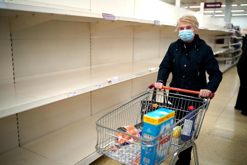 A woman walks past empty shelves as they shop at Sainsbury's in Northwich (Getty Images)