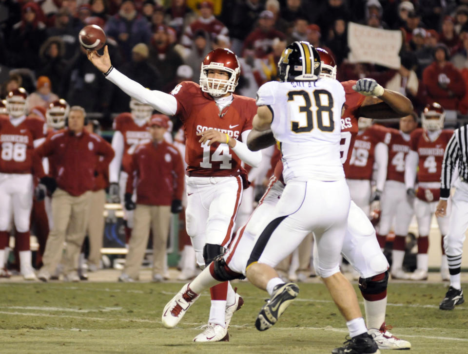 Dec. 6, 2008; Kansas City, Missouri; Oklahoma Sooners quarterback Sam Bradford (14) throws a pass during the first half of the Big 12 championship game against the Missouri Tigers at Arrowhead Stadium. Jeff Curry-USA TODAY Sports