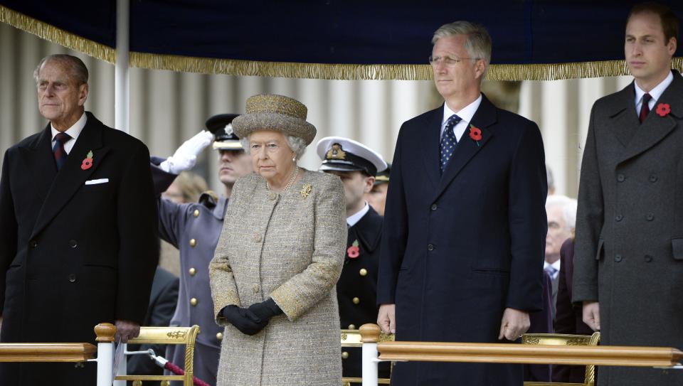 FILE - In this Thursday, Nov. 6, 2014 file photo, from left, Britain's Prince Philip and Queen Elizabeth stand with Belgium's King Philippe and Britain's Prince William during the opening of the Flanders' Fields Memorial Garden at Wellington Barracks in London. Prince Philip's life spanned just under an entire century of European history. His genealogy was just as broad, with Britain's longest-serving consort linked by blood and marriage to most of the continent's royal houses. (AP Photo/Eric Lalmand, File)