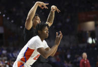 Florida guard Tyree Appleby (22) and Keyontae Johnson, top, celebrate a three-point basket against Troy during the second half of an NCAA college basketball game Sunday, Nov. 28, 2021, in Gainesville, Fla. (AP Photo/Matt Stamey)