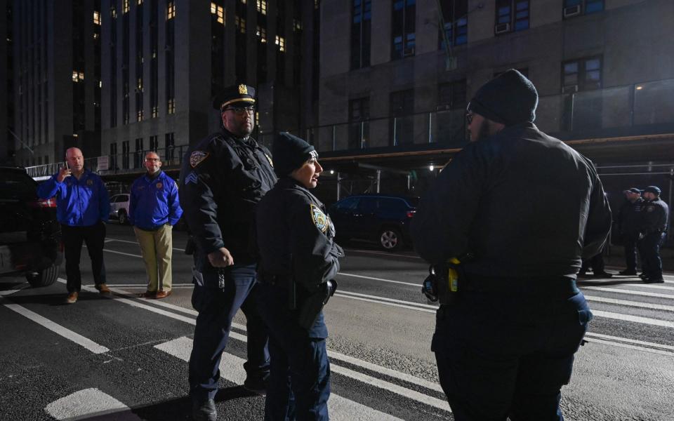 NYPD officers stands outside the Manhattan District Attorney's office - Getty