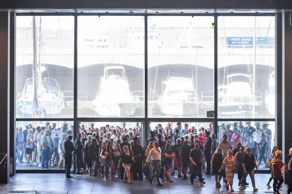 People gather outside the Fair of Genoa to attend State funerals of the victims of the collapse (EPA)