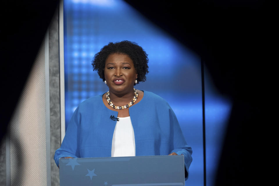 FILE - Democratic challenger Stacey Abrams faces off with Republican Georgia Gov. Brian Kemp in a televised debate, Oct. 30, 2022, in Atlanta. A lawsuit that plaintiffs say could deter mass voter challenges around the country ahead of the 2024 election is headed to trial in Georgia on Thursday, Oct. 26, 2023. A group associated with Abrams accuses Texas-based True the Vote of trying to intimidate voters ahead of a 2021 Senate runoff election in Georgia. (AP Photo/Ben Gray, File)