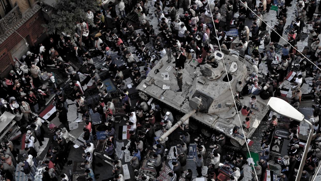  Peaceful protesters pray around an army tank near Tahrir Square, Cairo in 2011. 