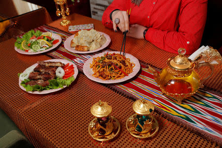 A woman eats lunch at an Uighur restaurant in Istanbul, Turkey, March 2, 2019. Owner and chef Mohammed Siddiq says his restaurant is suffering because Uighurs tend to eat at home and Turks are not interested in Uighur food. REUTERS/Murad Sezer