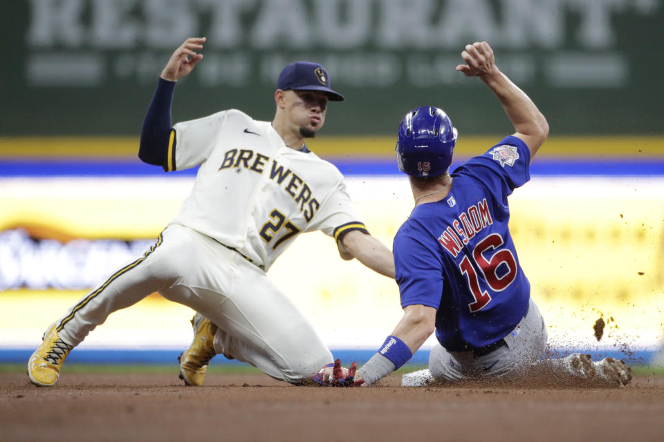 Milwaukee Brewers' Willy Adames (27) tags Chicago Cubs' Patrick Wisdom (16) out as he attempts to steal second base during the second inning of a baseball game Tuesday, June 29, 2021, in Milwaukee. (AP Photo/Aaron Gash)