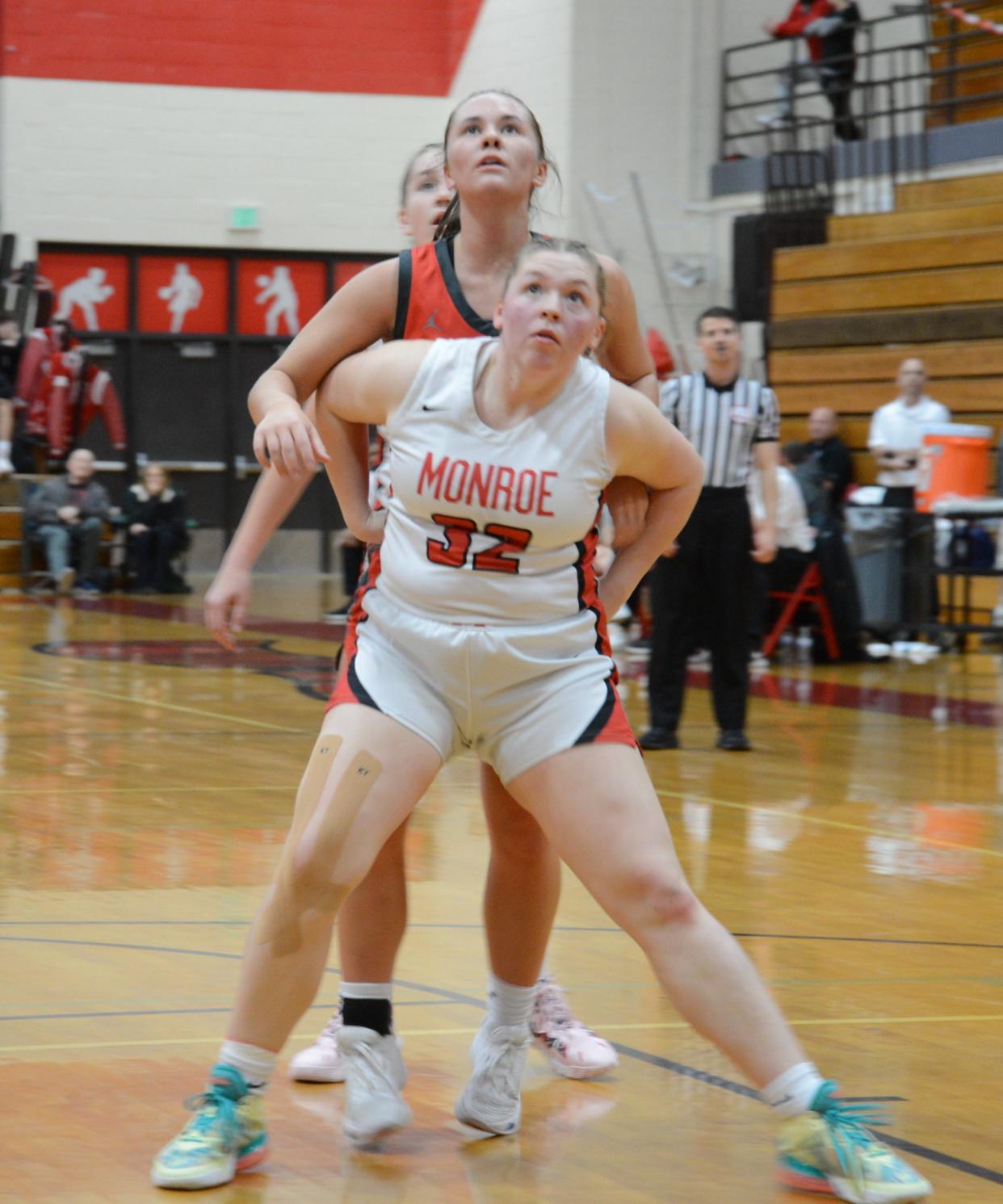 Monroe's Alana Aulph boxes out Payton Pudlowski of Bedford Friday night. Bedford won 50-7.