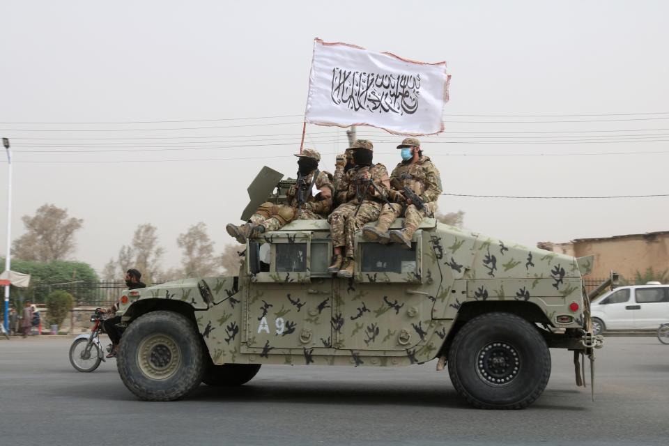 Taliban fighters patrol on the road during a celebration marking the second anniversary of the withdrawal of U.S.-led troops from Afghanistan, in Kandahar, south of Kabul, Afghanistan, Tuesday, Aug. 15, 2023.