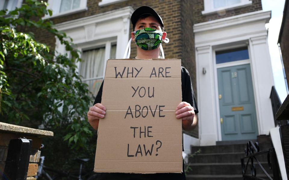 A protester demonstrates outside the home of British Prime Minister Boris Johnson's Special Advisor, Dominic Cummings, in London, Britain, 24 May 2020 - SHUTTERSTOCK