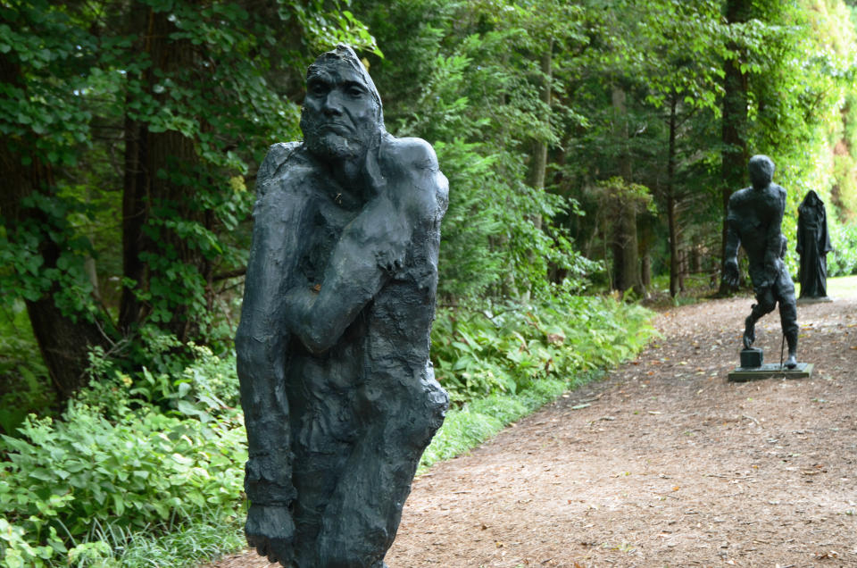Large bronze sculptures from the series, "Myth of Singularity" by artist Liz Glynn line a pathway at The Watermill Center, Saturday, Sept. 17, 2022, in Water Mill, N.Y. The Watermill Center, founded in 1992 by theater director and artist Robert Wilson, offers artist residencies and educational programs. (AP Photo/Pamela Hassell)
