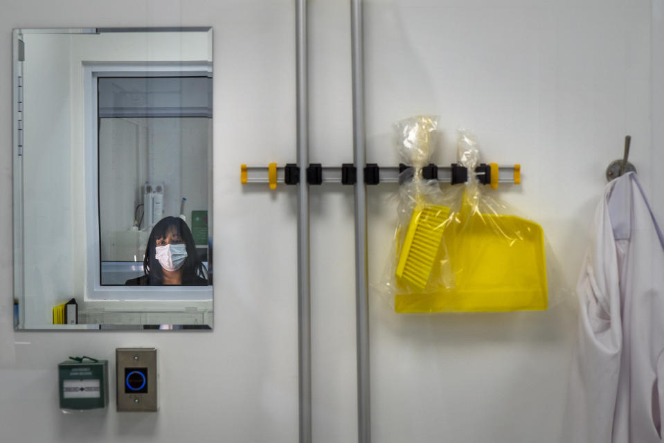 Caryn Fenner, Afrigen Biologics and Vaccines technical director, is reflected in a mirror inside a research lab in Cape Town, South Africa, Tuesday, Oct. 19, 2021. At the lab, a team of young scientists is assembling the equipment needed to reverse engineer Moderna's coronavirus vaccine. “The excitement is around learning how we harness mRNA technology to develop a COVID-19 vaccine,” Fenner said. ​(AP Photo/Jerome Delay) (I’d cut the last sentence)