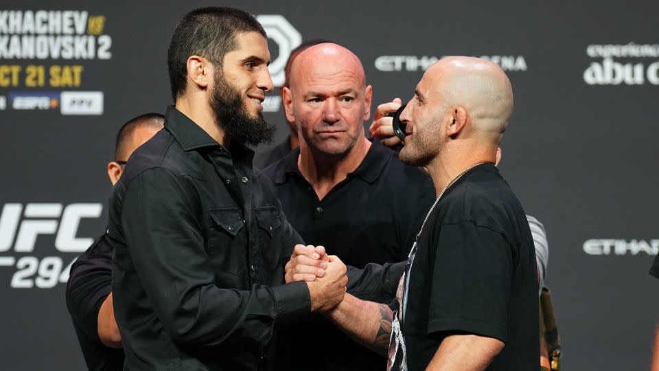 Volkanovski and Makhachev shake hands during a press conference ahead of their lightweight fight at UFC 294. - Chris Unger/Zuffa LLC/Getty Images