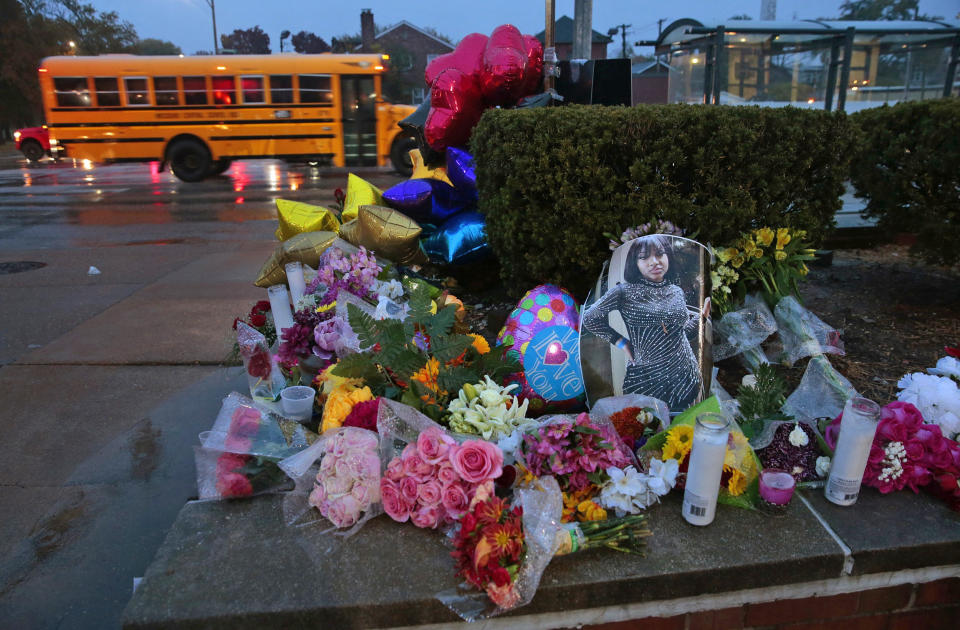 A photo of Alexzandria Bell sits among flowers and candles left as a memorial to the victims of a school shooting at Central Visual & Performing Arts High School on Oct. 25, 2022, in St. Louis. (Robert Cohen / St. Louis Post-Dispatch via AP)