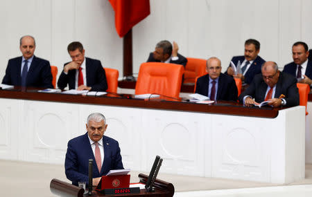 Turkey's new Prime Minister Binali Yildirim reads his government's programme at the Turkish parliament in Ankara, Turkey, May 24, 2016. REUTERS/Umit Bektas