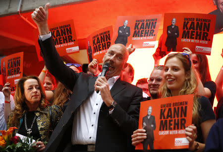 Carsten Meyer-Heder, Germany's Christian Democratic Union party (CDU) top candidate for the German city-state of Bremen parliamentary elections speaks next to his wife Anja after first election polls were published in Bremen, Germany, May 26, 2019. REUTERS/Wolfgang Rattay