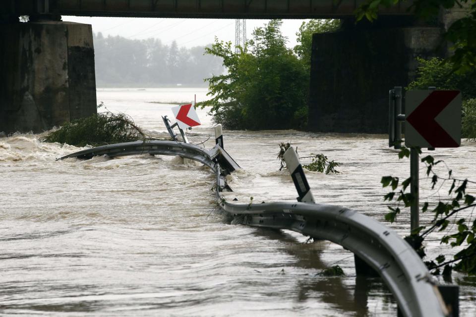 General view of a buckled crash barrier on a flooded road near Grabenstaett