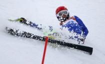 Slovakia's Barbora Lukacova slides down the course after crashing in the first run of the women's alpine skiing slalom event during the 2014 Sochi Winter Olympics at the Rosa Khutor Alpine Center February 21, 2014. REUTERS/Leonhard Foeger (RUSSIA - Tags: SPORT OLYMPICS SPORT SKIING)