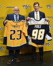 Former Nashville Predators head coach Barry Trotz, left, and general manager David Poile, pose for a photograph after a news conference Monday, Feb. 27, 2023, in Nashville, Tenn. Trotz will become the next general manager of the Nashville Predators after David Poile retires in June. (AP Photo/Mark Zaleski)