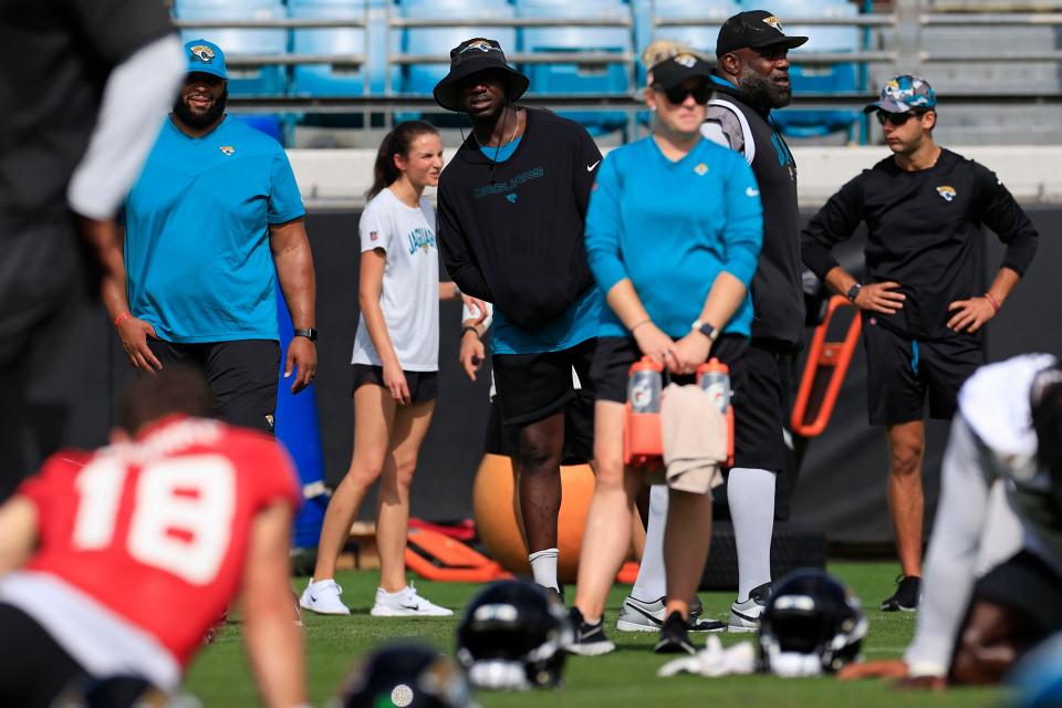 Jacksonville Jaguars linebacker Foyesade Oluokun, center, black shirt, bucket hat, looks on from the sideline during the third and final day of a mandatory minicamp Monday, June 12, 2023 at TIAA Bank Field in Jacksonville, Fla. 