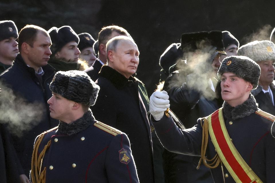 FILE - Russian President Vladimir Putin, center left, attends a wreath-laying ceremony at the Tomb of the Unknown Soldier, near the Kremlin Wall during the national celebrations of the "Defender of the Fatherland Day" in Moscow, Russia, on Feb. 23, 2023. (Valery Sharifulin, Sputnik, Kremlin Pool Photo via AP, File)
