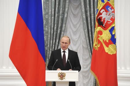 Russian President Vladimir Putin delivers a speech during a meeting at Kremlin in Moscow July 31, 2014. REUTERS/Mikhail Klimentyev/RIA Novosti/Kremlin